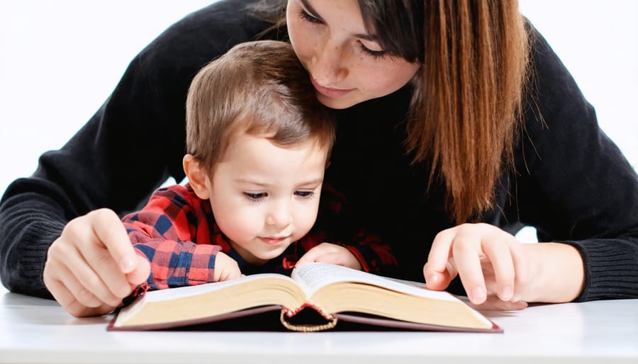 Parent and child studying the Bible together on a couch