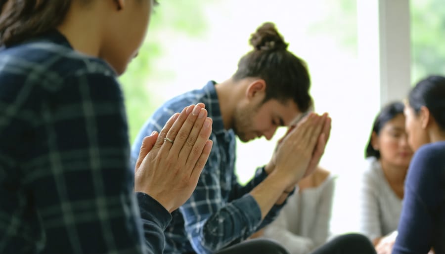 People gathered in prayer during a recovery support group meeting