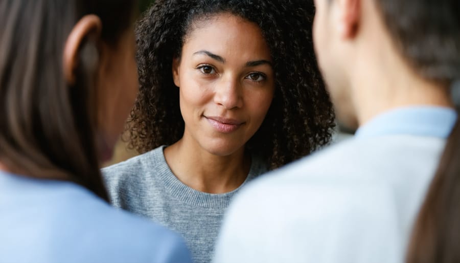 Christian counselor speaking with empathy to a counselee in a warm, welcoming setting