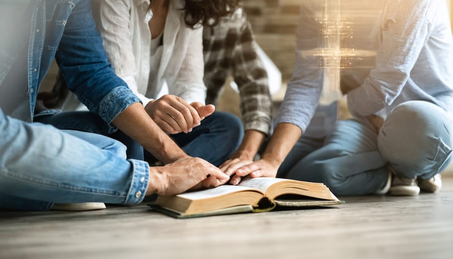 Diverse group of Christians praying together in a home fellowship group