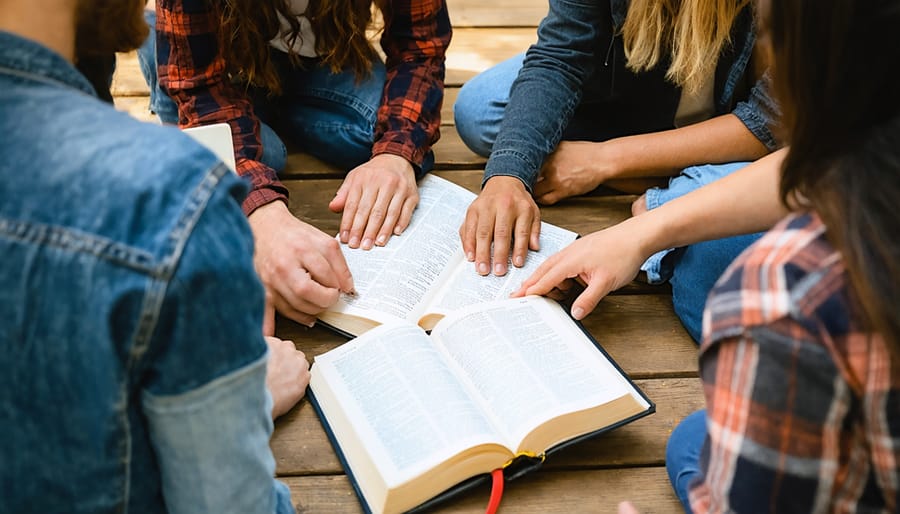 Diverse group engaged in collaborative Bible study and discussion