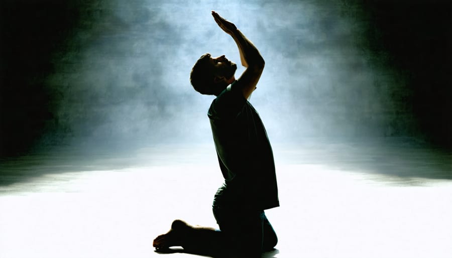 Silhouette of person praying with raised hands in a peaceful setting