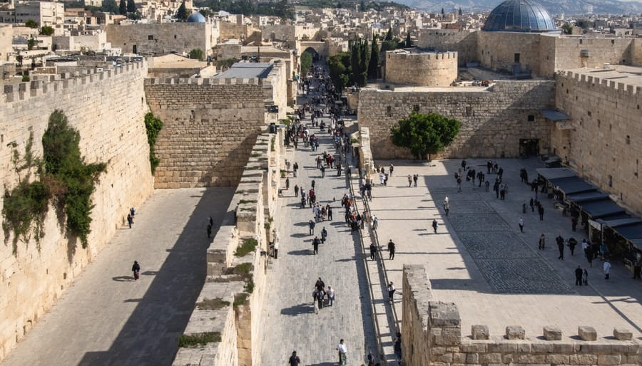 Bird's eye view of the winding Via Dolorosa path through Jerusalem with pilgrims walking the Stations of the Cross