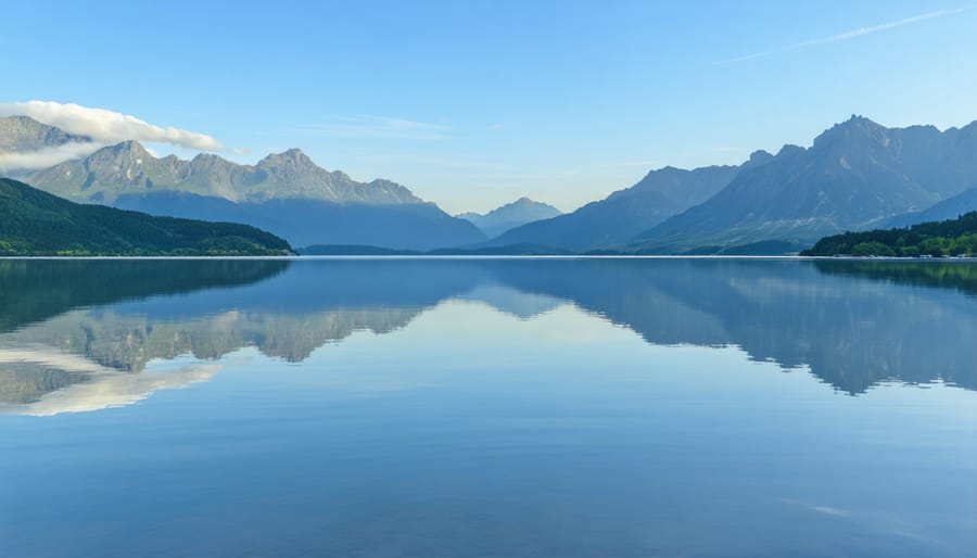 Tranquil lake scene with mountain reflections representing spiritual peace